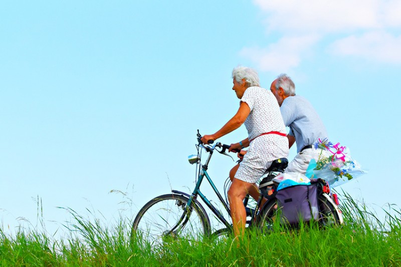 Two elderly individuals cycling